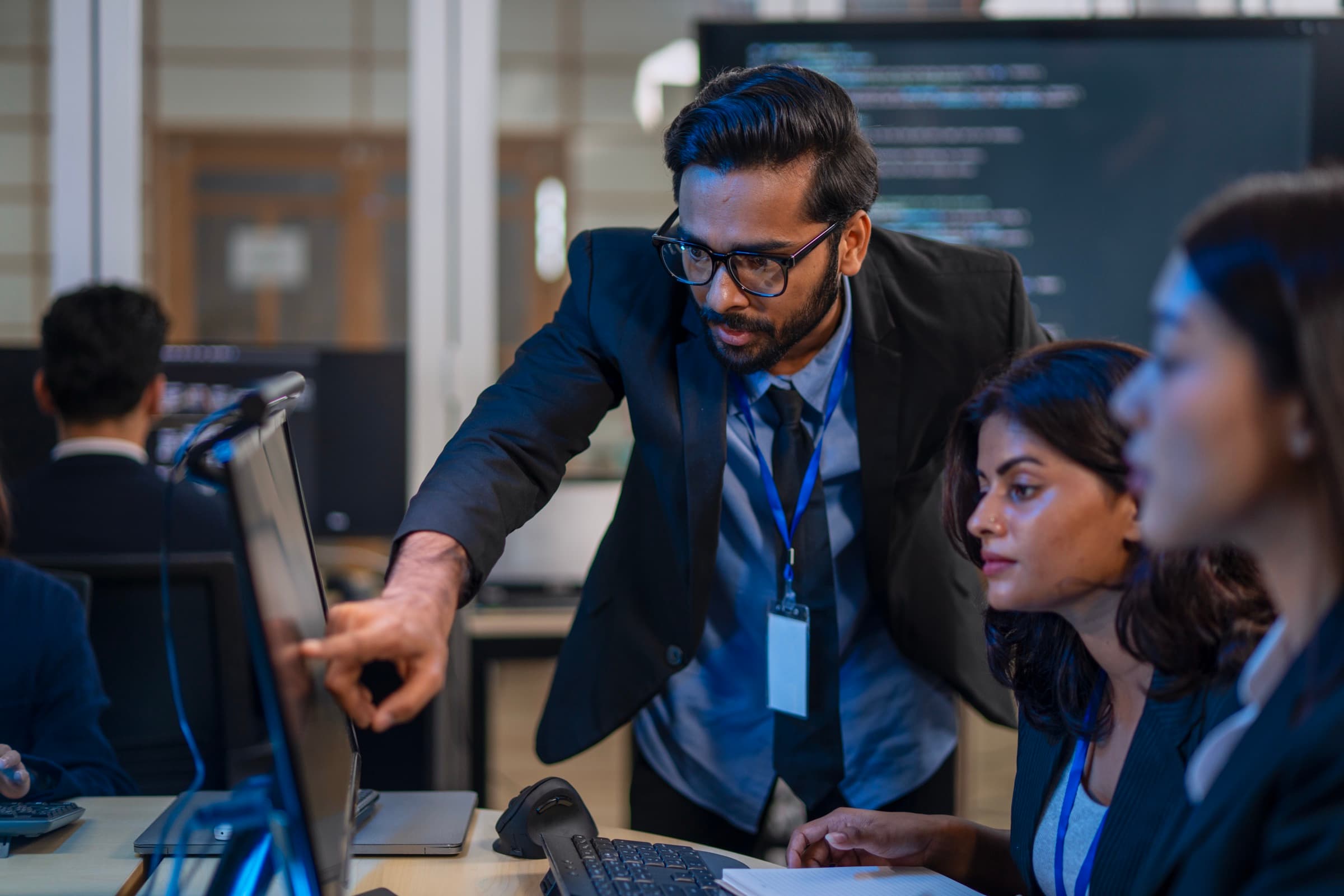 Enterprise technology specialists reviewing systems at workstations